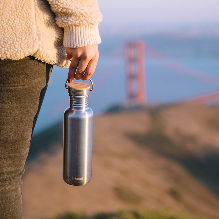 27oz-reflect-with-bamboo-cap-e9 K27SSLRF-BS-BAMBOO_reflect_bottle_bridge_lifestyle.jpg