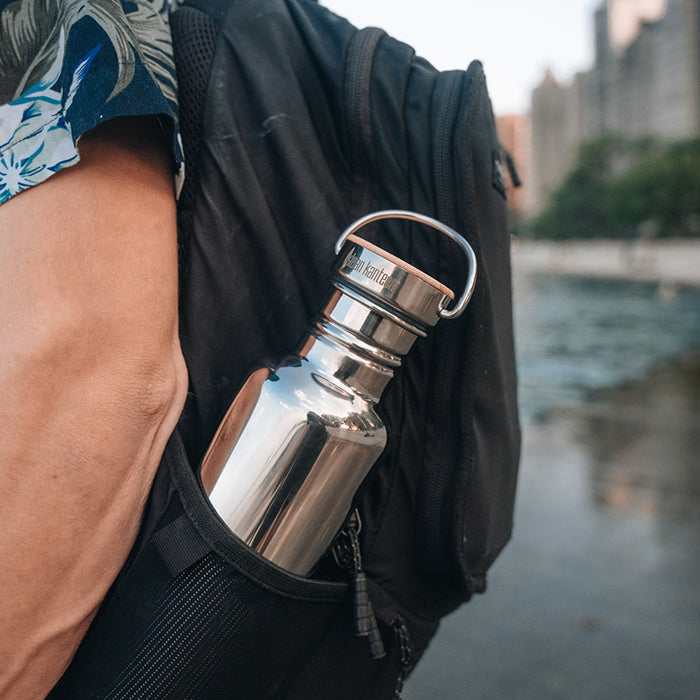 27oz-reflect-with-bamboo-cap-e9 K27SSLRF-MS-BAMBOO_reflect-bottle_backpack_lifestyle.jpg